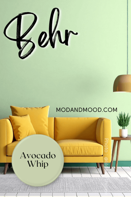 Behr Avocado Whip on a wall behind a mustard sofa.