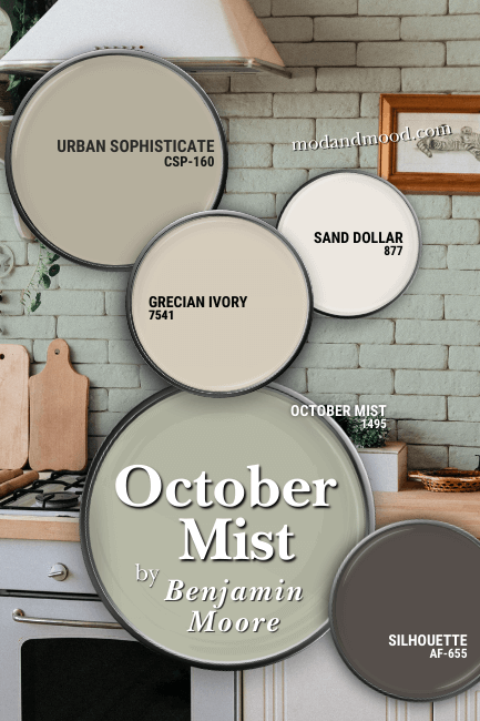 Benjamin Moore October Mist in a color palette featues: Urban Sophisticate, Grecian Ivory, Sand Dollar, Silhouette, and October Mist, all on paint lids over a background of that color on a brick kitchen wall.
