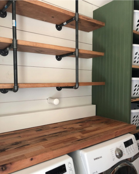 Sherwin Williams Oak Moss on laundry room cabinets with wooden shelves.