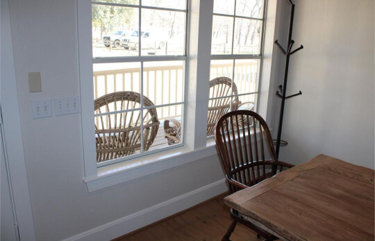 Aesthetic White Walls with Snowbound Trim in a dining room by a window
