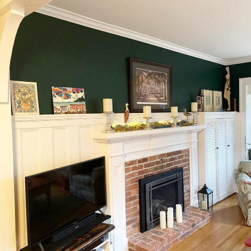 Benjamin Moore Hunter green in a living room with white wainscoting on the lower 2/3 of the wall.