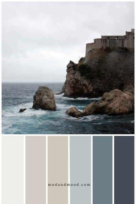 A picture of a rainy day on the ocean with beige cliffs and blue water over blue and greige paint colors