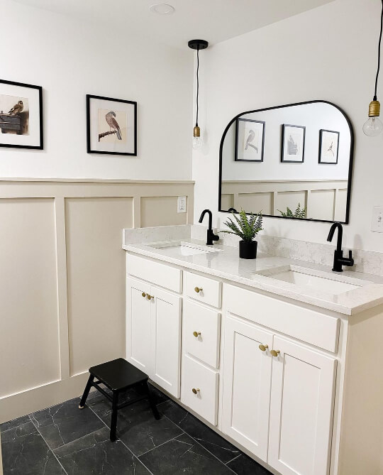 Accessible beige board and batten with Alabaster walls in a bathroom with black floors, and cream vanity