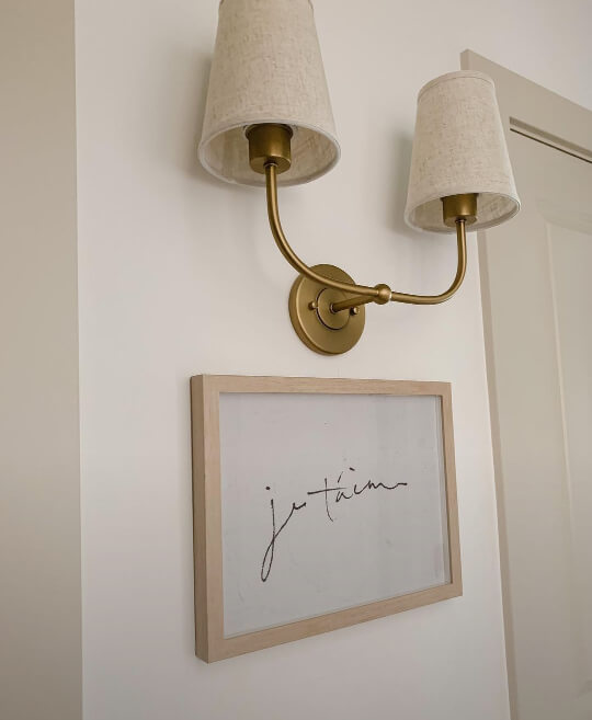 Accessible beige on wall trim with a sconce.