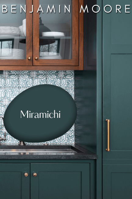Swatch of Benjamin Moore Miramichi over a color match on kitchen cabinets.