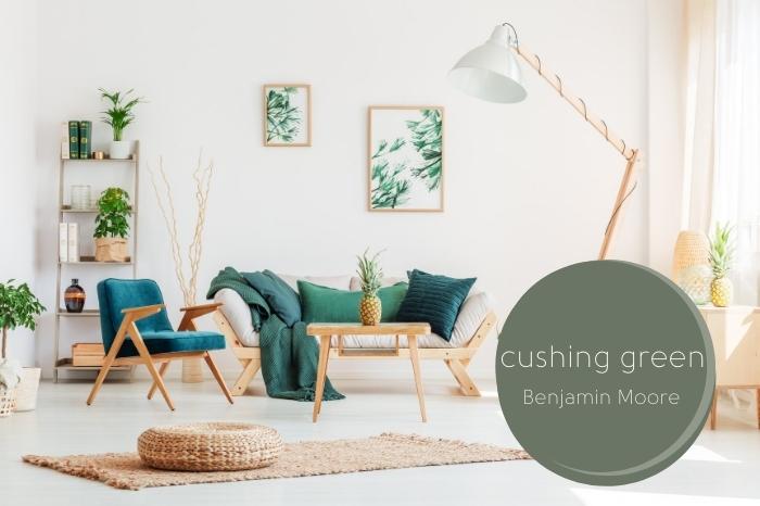 Benjamin Moore cushing green over a background of a bright white modern living room with natural wood furniture and green accents.