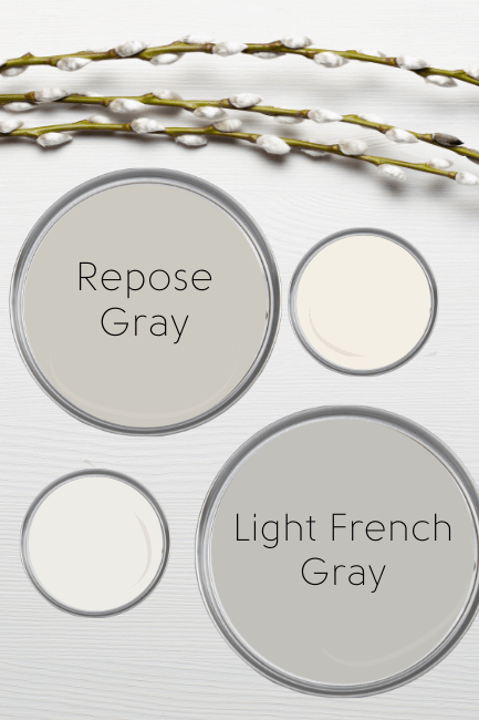A paint can lid labelled Repose Gray, beside a creamy white, and above another white and a paint can lid labelled light french gray. Background is white with willow branches.