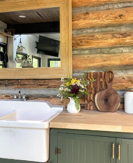Vintage vogue cabinets in a log cabin with butcher block counters