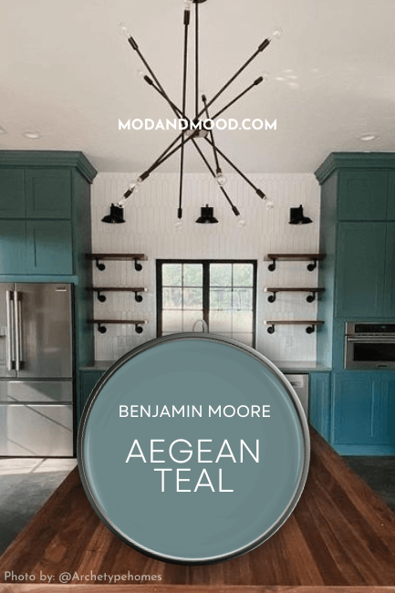 Benjamin Moore Aegean Teal swatched on a paint lid over a background of the color on kitchen cabinets.