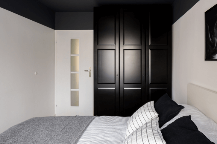 Black and White Bedroom with black closet and ceiling and white walls