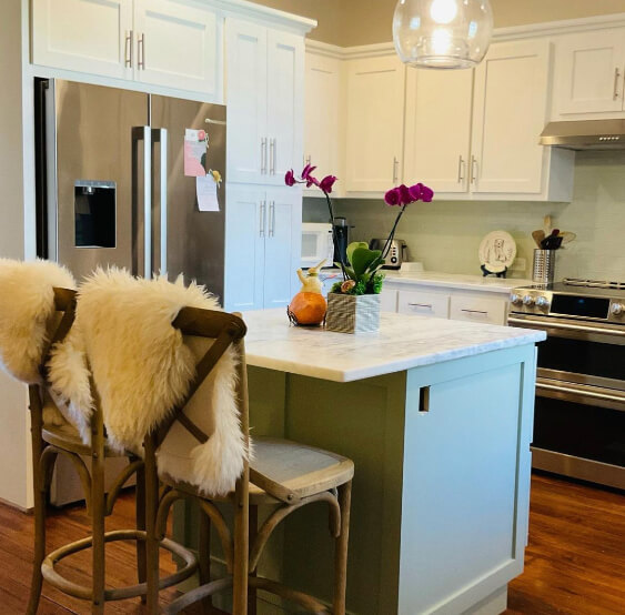 Clary Sage on a kitchen island with simply white walls and cabinets