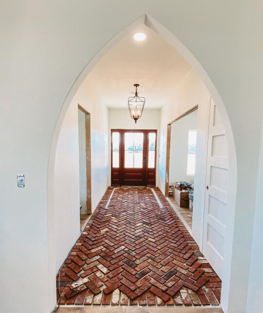 A beautiful arched foyer painted in Greek Villa.