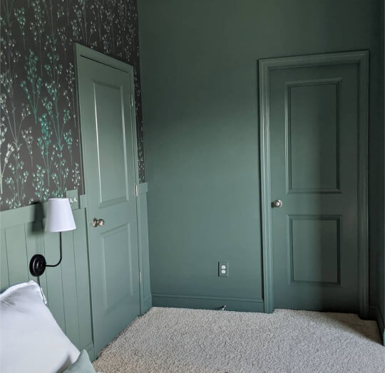 Heritage Park - a cool medium to dark gray green - on walls, doors, and trim in a bedroom with hand painted floral wallpaper   on half of one wall.