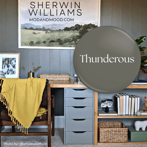 Swatch of Sherwin Williams Thunderous over a photo of the color on a shiplap wall behind a wood desk.