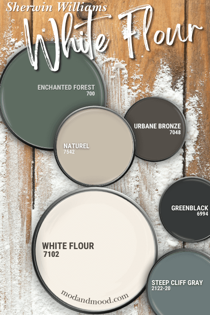 White flour on a paint lid with coordinating colors Enchanted Forest, Urbane Bronze, Steep cliff gray, Greenblack, and Naturel, over a floured wood surface.
