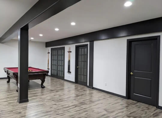 Black doors and trim in a billiards room