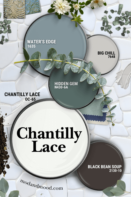Benjamin Moore Chantilly Lace with coordinating colors Water's Edge, Big Chill, Black Bean Soup, and Hidden Gem. All colors are swatched on paint lids, over a background of white pebble tiles with white grout, and scattered greenery, crystals, and tiles, all in coordinating colors.