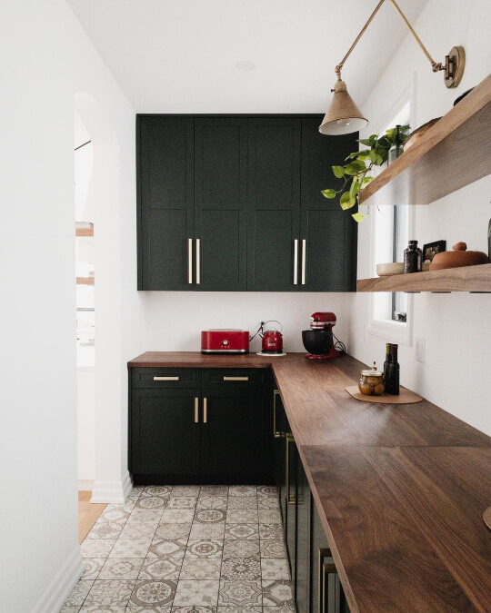 Galley kitchen with walnut countertops and essex green cabinets