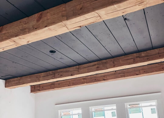 Close up of Cyberspace shiplap ceiling with natural wood beams