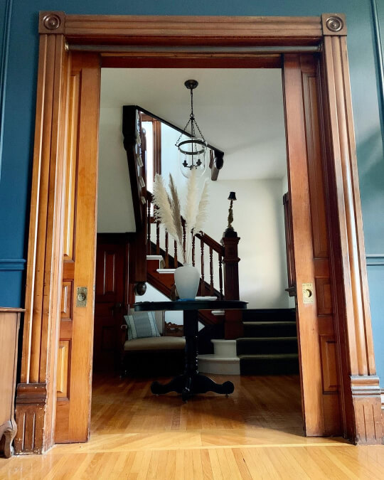 Hale Navy doorway with wood trim into white foyer