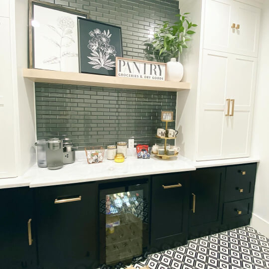 White cabinets with Tricorn black lower cabinets and gray tile