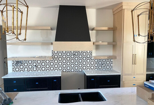 Tricorn black cabinets in white kitchen with black and white tile and open shelves