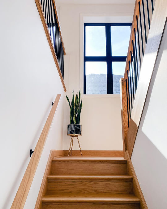 Chantilly lace in a stairwell with natural wood trim