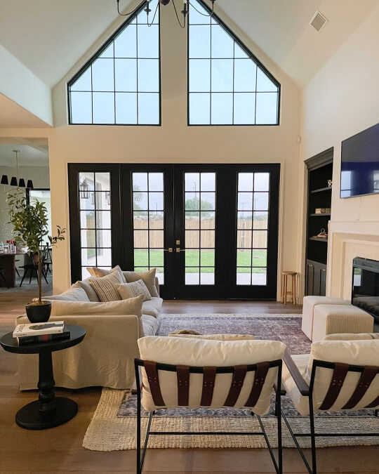Benjamin Moore Swiss coffee on walls and trim in vaulted living room with wall of windows