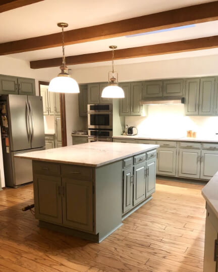 Sherwin Williams Evergreen Fog on perimeter kitchen cabinets and island in a very large kitchen.