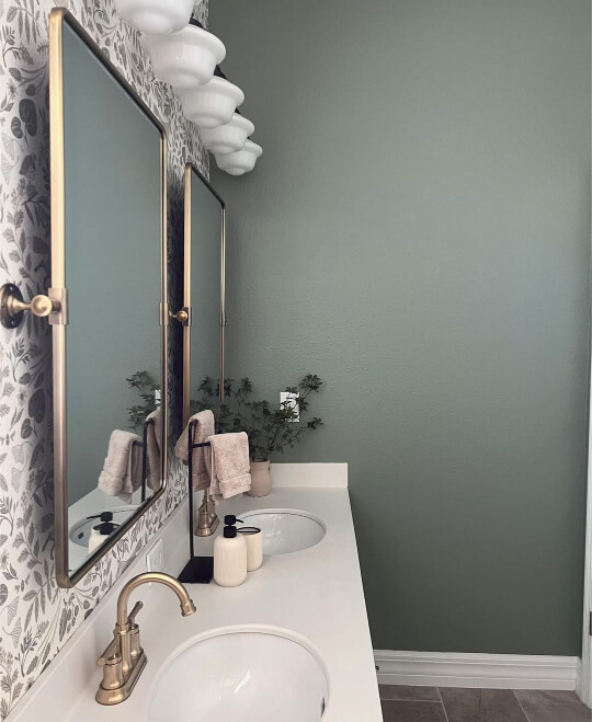 Pashmina double vanity in bathroom with wallpaper on sink wall and green gray evergreen fog on the rest