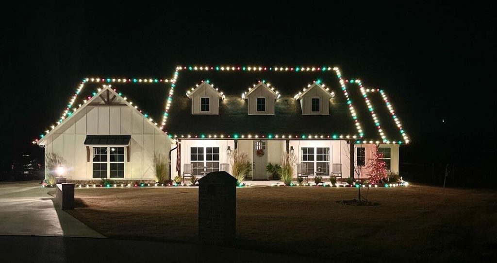 Simply White Exterior and Oyster Bay Front Door with Christmas Lights at night