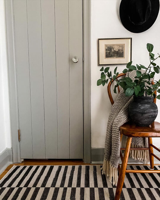 Sage green gray trim around a door of the same color with Simply White walls