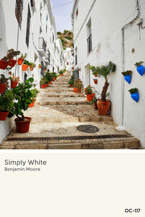 A sunny whitewashed village beside a swatch of simply white oc-117 by Benjamin Moore