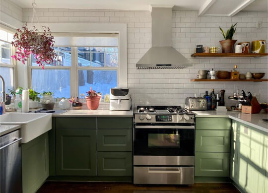 Benjamin Moore Vintage Vogue on cabinets in a bright white kitchen with chantilly lace walls, white subway tiles, and white countertops