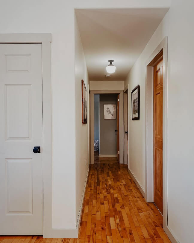 Benjamin Moore Revere Pewter on trim in a hallway with creamy white walls.
