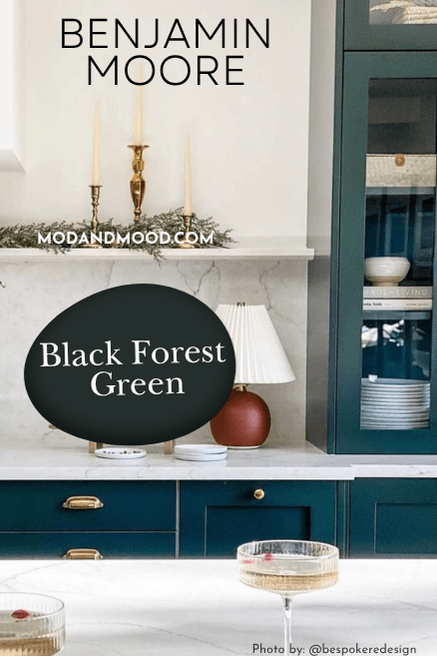 Swatch of Benjamin Moore Black Forest Green over a background of the colo on kitchen cabinets with white walls
