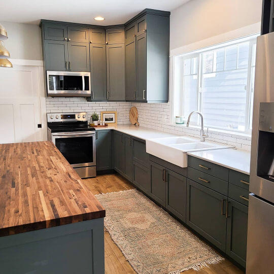 Homburg Gray on Kitchen cabinets with butcher block island and white countertops and white subway tile backsplash