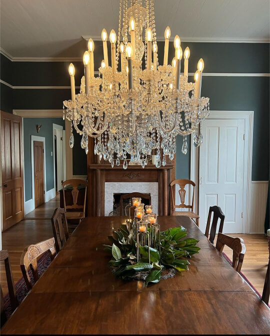 a lit chandelier hanging in formal dining room