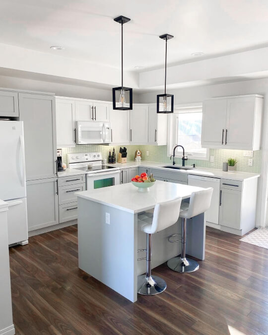 White and light gray two tone kitchen with bright natural light