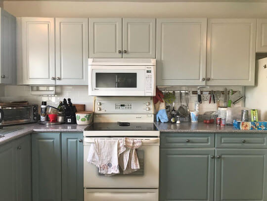 soft gray upper cabinets with gray green lowers in a two tone kitchen