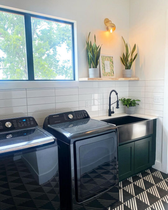 Jasper on laundry room sink cabinet with stacked tile walls and funky black and white geometric tile floors