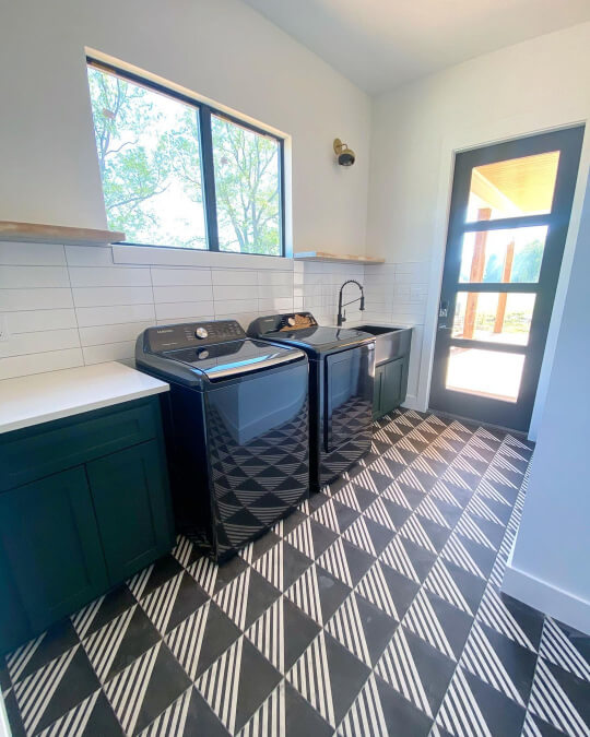 Jasper on laundry room cabinets with stacked tile walls and funky black and white geometric tile floors