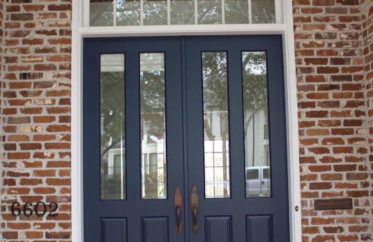 Sherwin williams Naval on the front door of a brick house with SW Extra White Trim