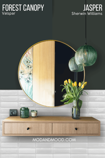 Sherwin Williams Jasper on half of a wall and Valspar dupe forest canopy on the other half behind a round mirror and a floating wood vanity.