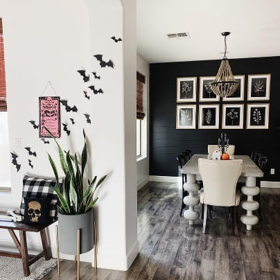 Tricorn black shiplap wall in dining room, as viewed from the white Behr Swiss Coffee halway, with tiny halloween bats on the wall