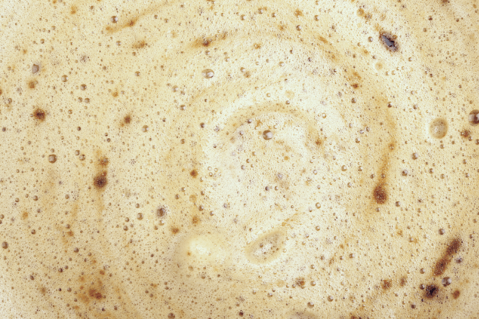a closeup of frothy milk on a coffee