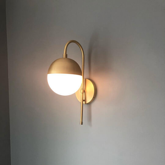 Foggy Day on a wall with a brass wall sconce in a bedroom.