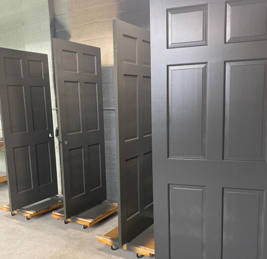 4 interior doors drying after being painted in Iron Ore