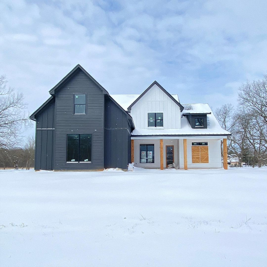 Sherwin Williams Iron Ore and Pure White on a modern farmhouse exterior on a snowy day