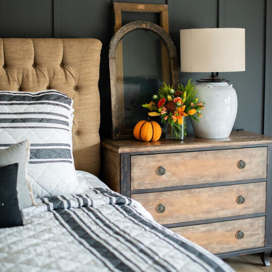 Iron Ore bedroom feature wall with seasonal fall decoration and gold velvet headboard